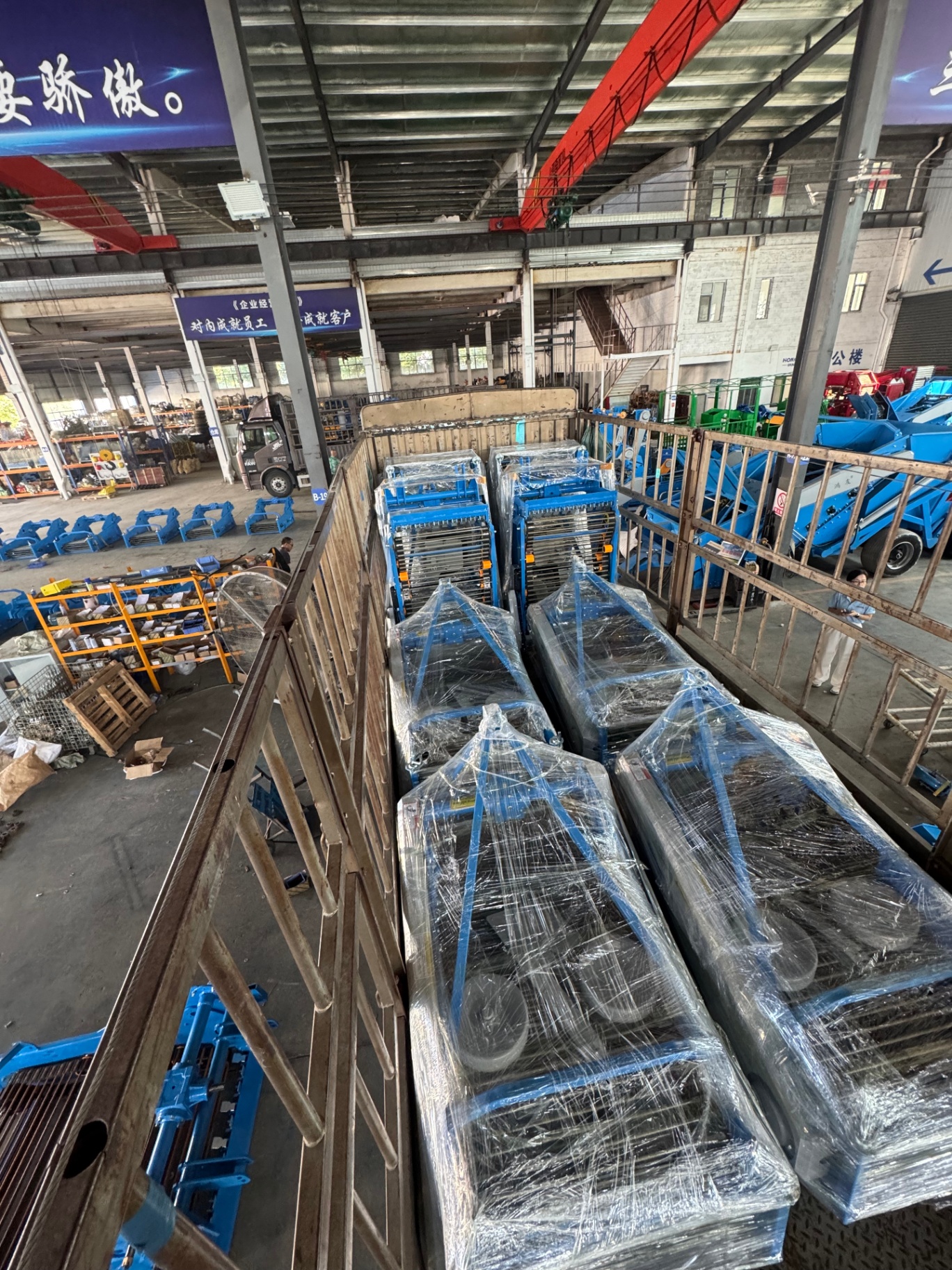 Batch of planters shrink-wrapped and crated, staged in the export yard.