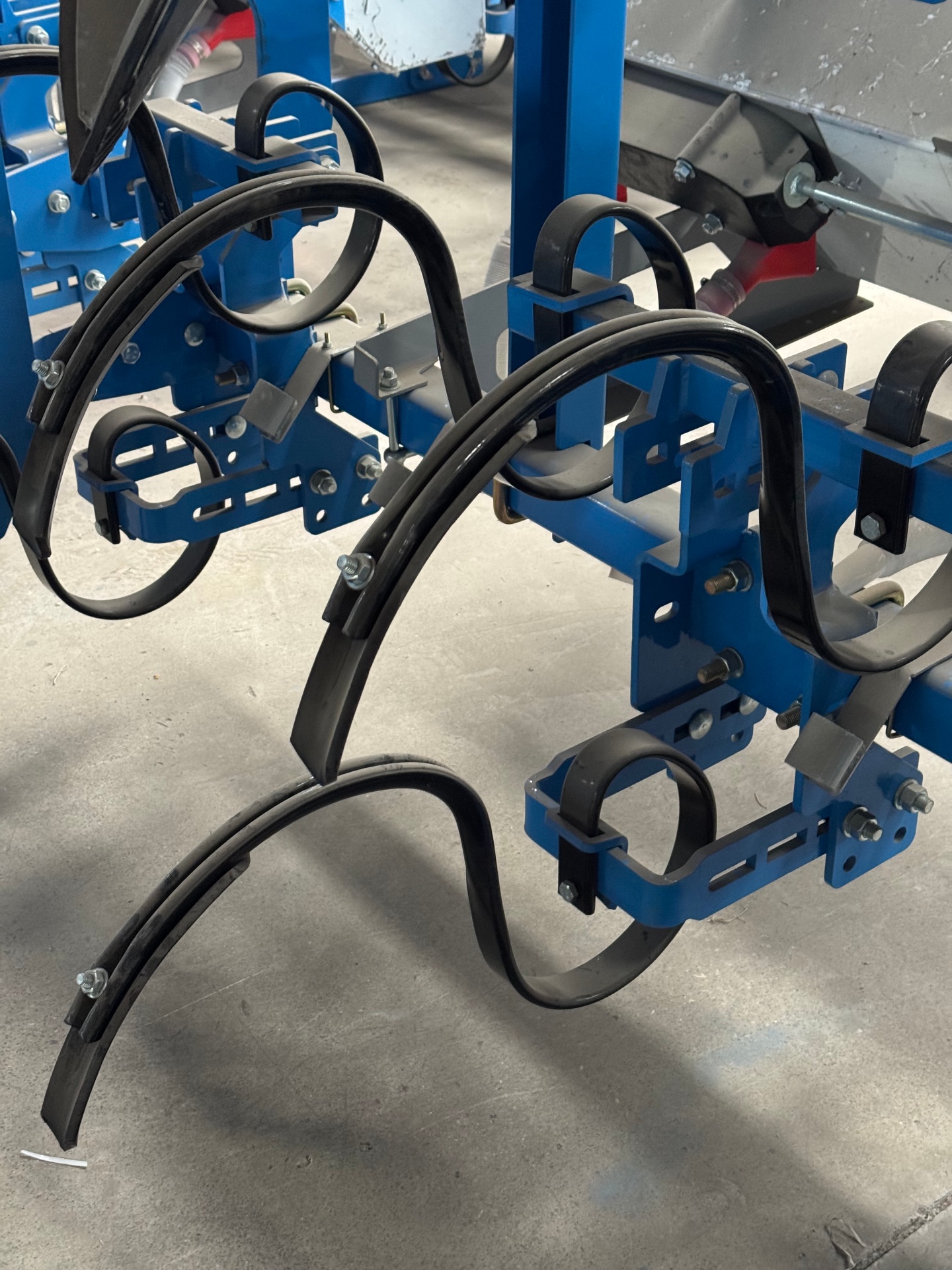 Spring-tine cultivator shank assemblies on parallelogram brackets
