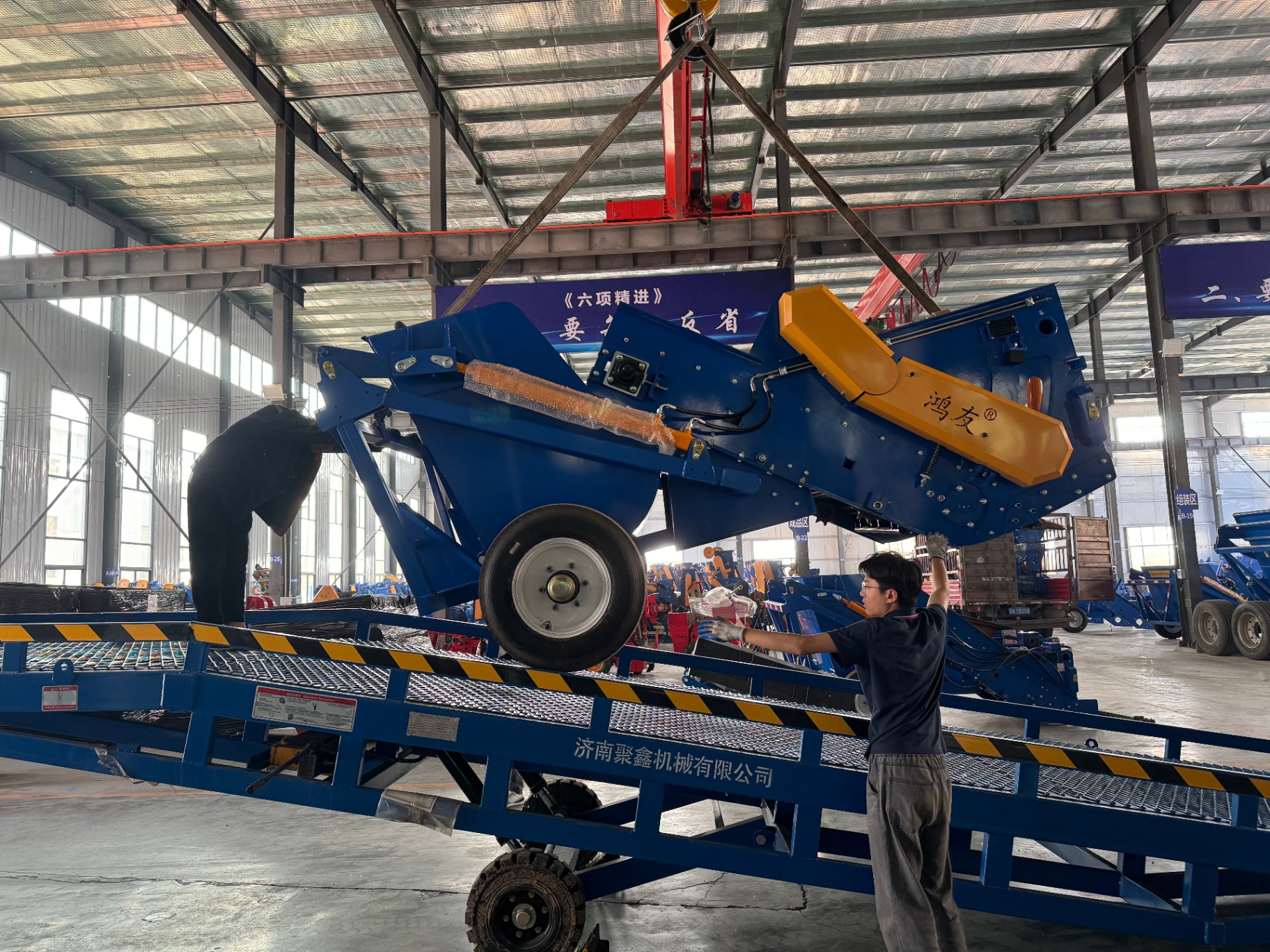 Loading view — machine lifted onto trailer