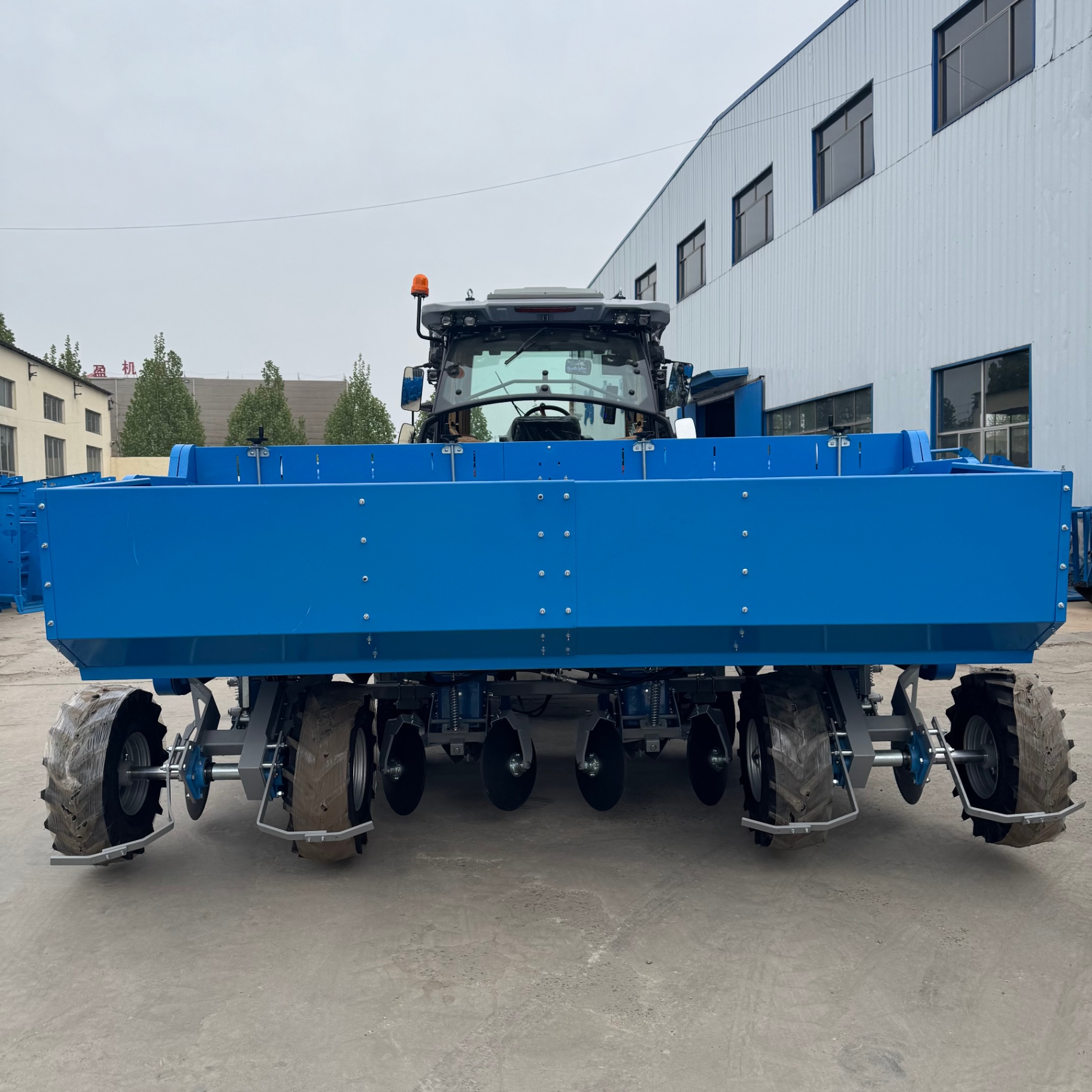 Rear view — wide hopper body and four-row layout