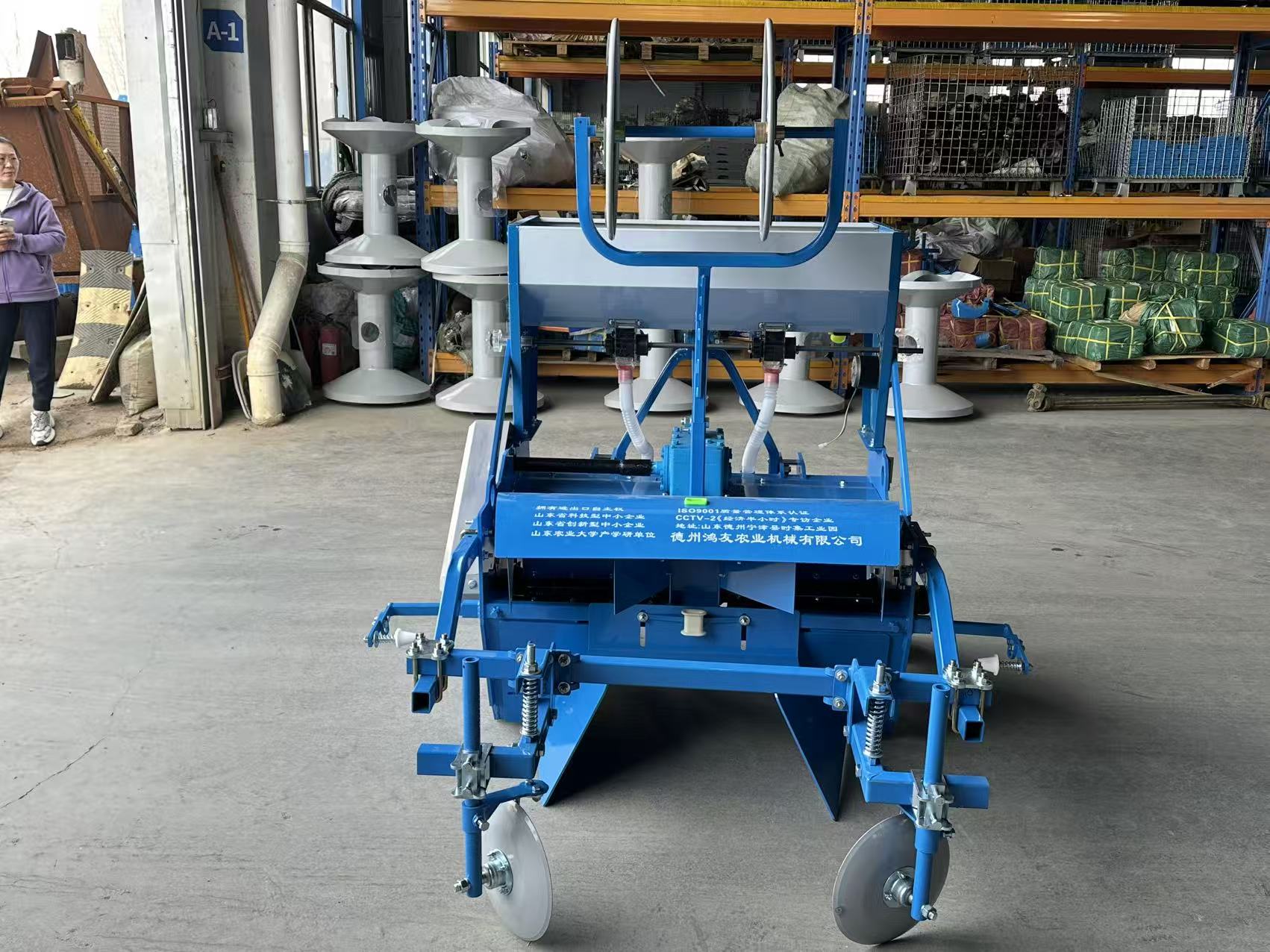 Front view — twin seed/fertilizer outlets and gauge wheels