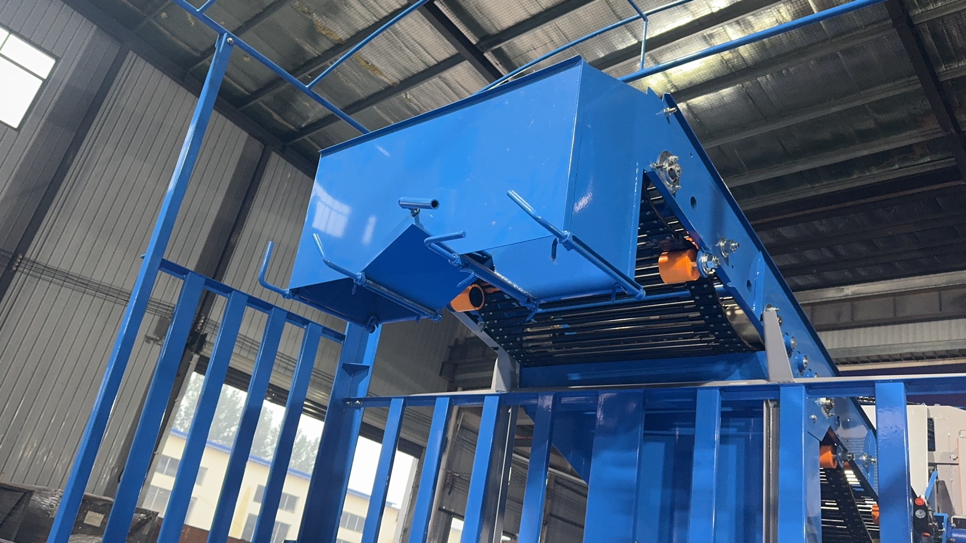 Hopper detail — discharge chute and conveyor drive