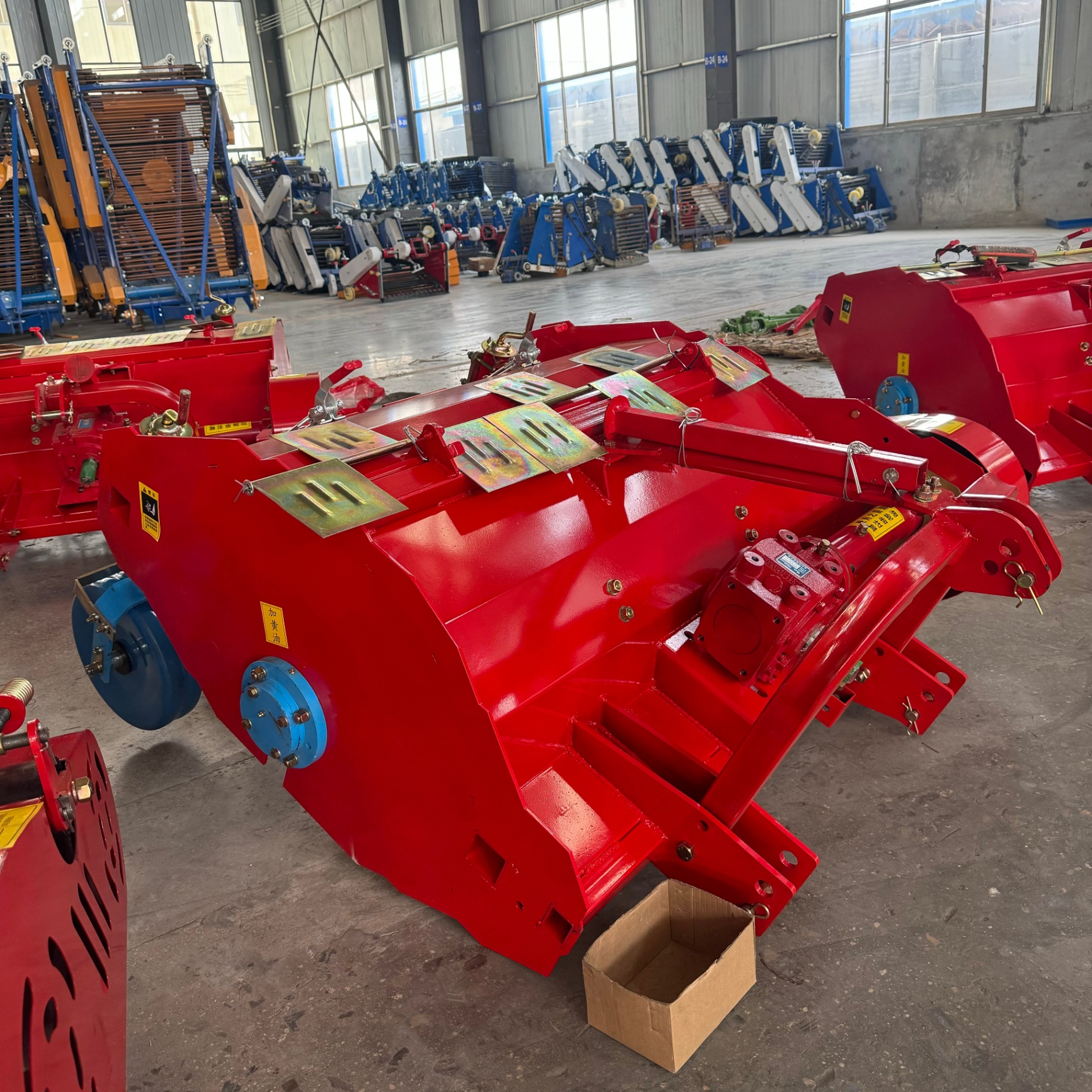 Rear view — heavy red hood, side gearbox and lifting frame