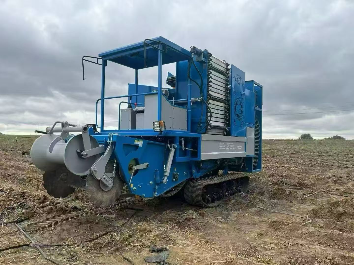 Field working view — tracked self-propelled harvester in operation
